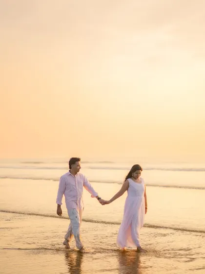 A classic romantic pre-wedding portrait taken during the golden hour at the beach. I use the soft, warm light of the sunset to create a dreamy and timeless image that focuses on the simple joy of a couple walking hand-in-hand by the sea.