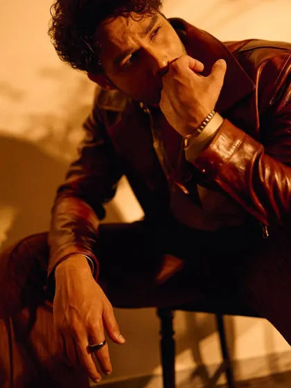A close-up detail of Siddhant's look, focusing on the accessories like the ring and bracelet that complete the retro-cool vibe.