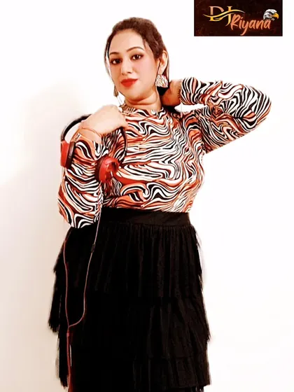 A stylish pose in a patterned top and black skirt, holding my red headphones. This look is all about moving to the rhythm of love.