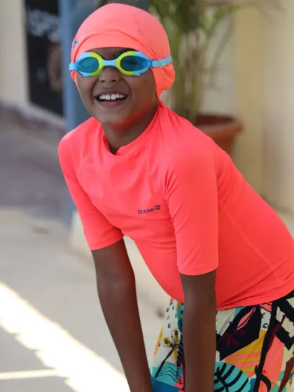 A bright smile from a happy swimmer. This is the result of a positive learning environment where kids feel accomplished and proud.