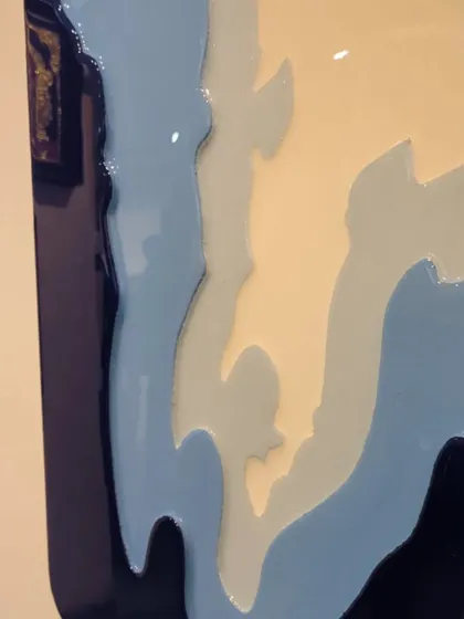 A side view of the Mumbai map artwork, highlighting the 3D, topographical effect created by the different layers of resin.