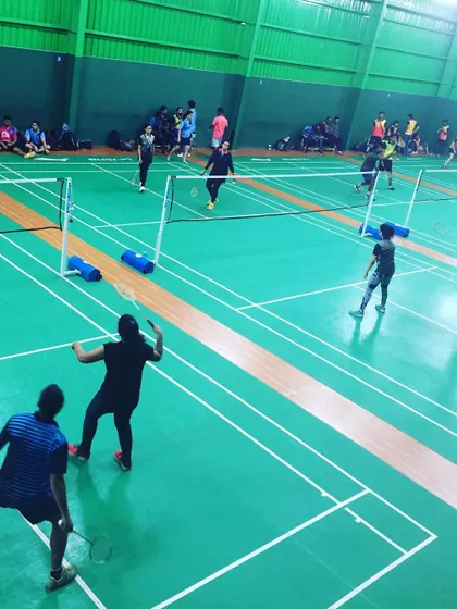 A doubles match in progress, showcasing the teamwork involved. Badminton is an excellent sport for building communication and strategic thinking among colleagues.