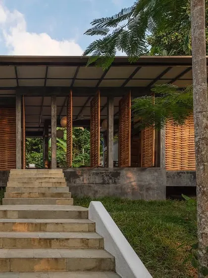 The approach to the private villa at Jalakara, with steps leading up to a structure that feels completely integrated with the hillside.