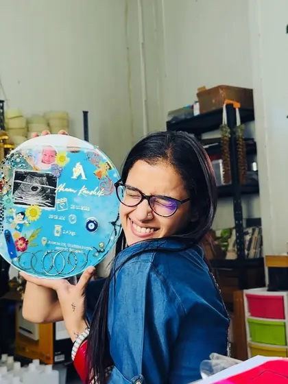 My happy smile holding this completed baby keepsake frame. It brings me so much joy to create pieces that I know will be cherished by a family for generations to come.