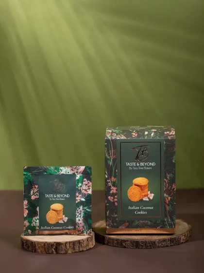 A naturally styled shot of Taste & Beyond cookie packaging on wooden discs, with soft, dappled lighting. This setup creates a warm, organic, and wholesome brand image.