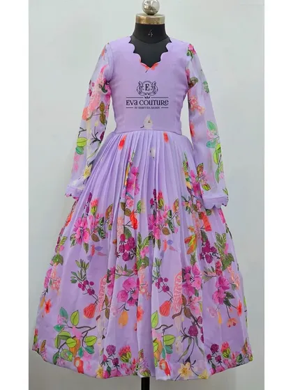 A single view of the lavender floral gown. The design features a scalloped V-neck and a flowing, pleated skirt, combining modern style with a touch of traditional print.