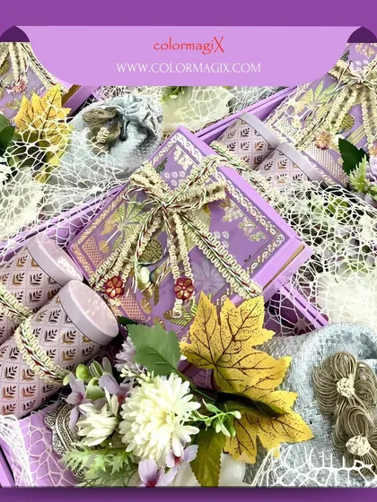 A luxurious wedding hamper in a regal purple theme. The box is lavishly decorated with flowers, ribbons, and ornate jars, making it a truly special gift for the wedding season.