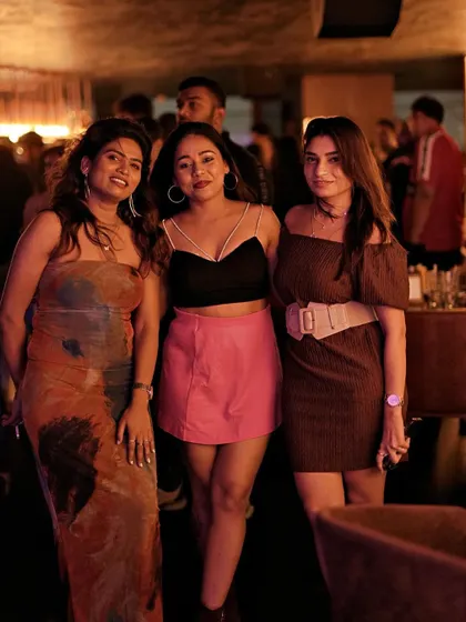 A group of three friends dressed up for a Saturday night at Kaze.