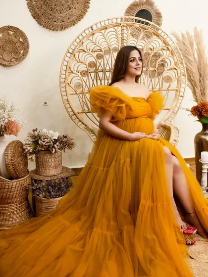 A beautiful boho-themed setup featuring a mustard yellow tulle gown and the classic peacock chair. The rustic, neutral-toned props complete this warm and earthy look.