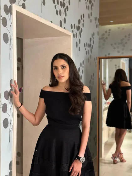 A classic little black dress for a premiere. This off-the-shoulder Alexander McQueen dress is the definition of timeless elegance.