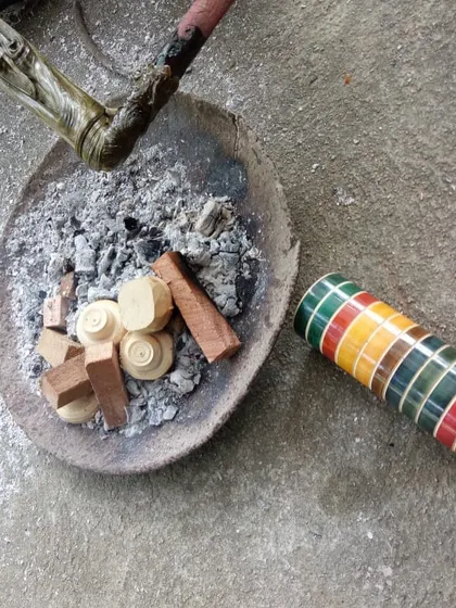 Natural lacquers, derived from organic sources, are prepared for application. Unlike synthetic colors, these traditional dyes create beautiful, varying tonalities in the finished woodcraft.