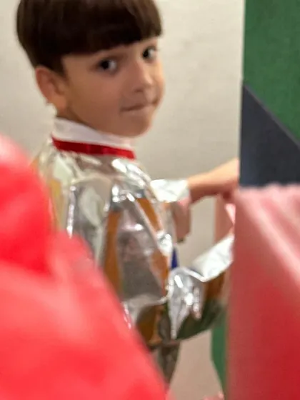 A peek from behind the blocks. Our little astronaut takes a moment from his space exploration to give a knowing glance.