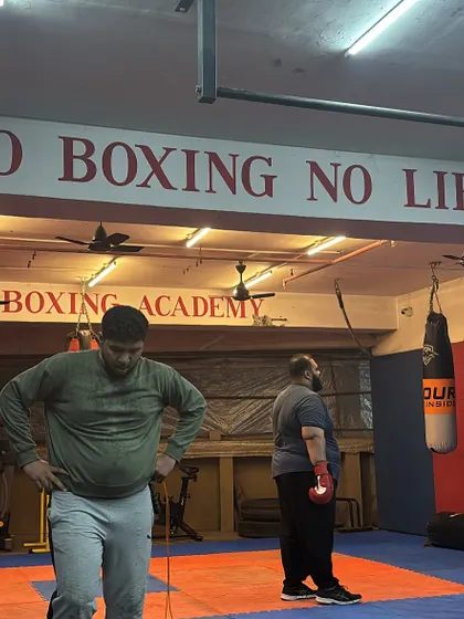 A moment to catch a breath before the next round. The motto on the wall, "NO BOXING NO LIFE," is the philosophy we live by in our academy.