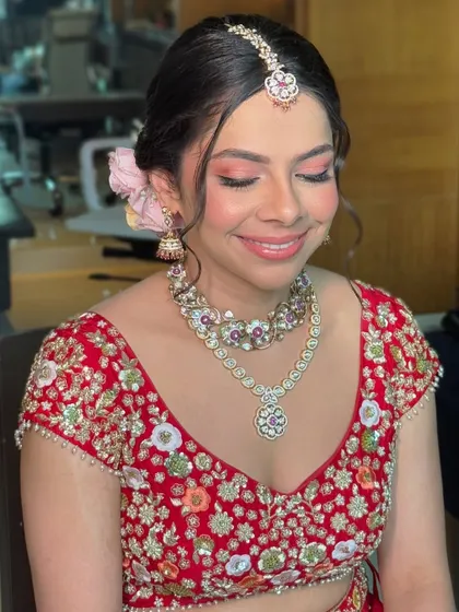 A happy, closed-eye shot showing the delicate blend of eyeshadow. The soft pink and shimmer create a romantic feel, perfect for a day wedding.