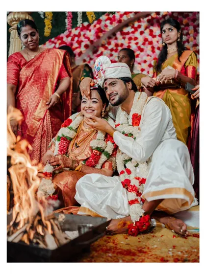 A sweet moment during the wedding ceremony, with the groom gently touching his bride's face.