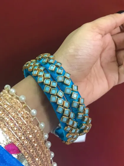 A set of sky blue silk thread bangles with square kundan stone work. This design is available for colour and size customisation.