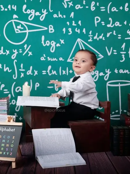 This little scholar is ready to solve some equations. Our "Tiny Mathematician" theme features a chalkboard full of formulas, books, and a globe for a smart and fun photoshoot.