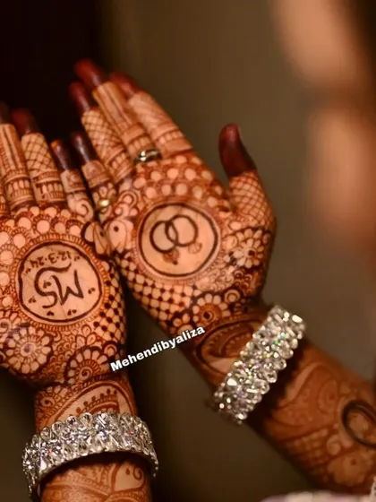 A close-up of the engagement henna, focusing on the personalized details that make the design unique to the couple.