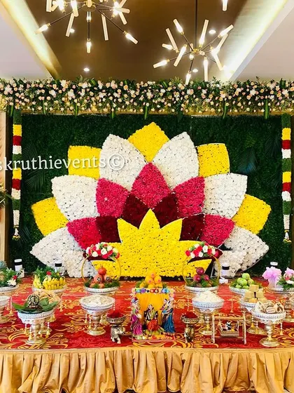 A full view of our grand lotus flower mosaic backdrop. This setup includes an elaborate display of offerings and traditional dolls, creating a complete and festive scene.