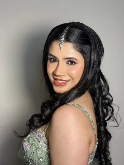 "There she glows." This portrait captures the bride's radiant smile and the flawless, glowing finish of her makeup.