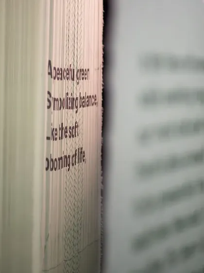 A close-up of text printed on layered fabric for the 'Cherish' installation. This detail highlights our belief that every element, from the choice of font to the texture of the material, contributes to the overall narrative of an exhibit.