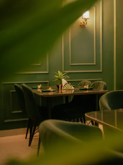 Another perspective of the dining area, showing the warm lighting and sophisticated wall molding.