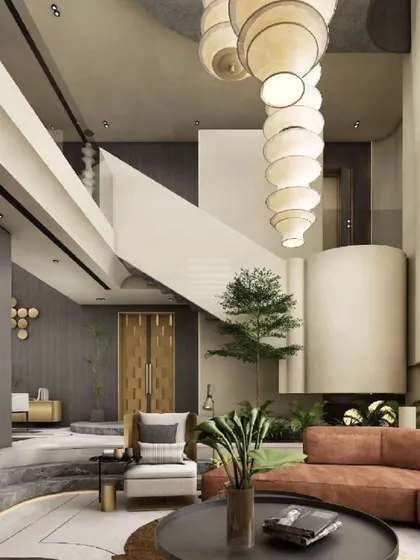 This contemporary living room is designed for both grandeur and tranquility. A double-height space is anchored by a sculptural paper lantern chandelier, while a large orange sofa adds a warm, inviting touch to the minimalist interior.