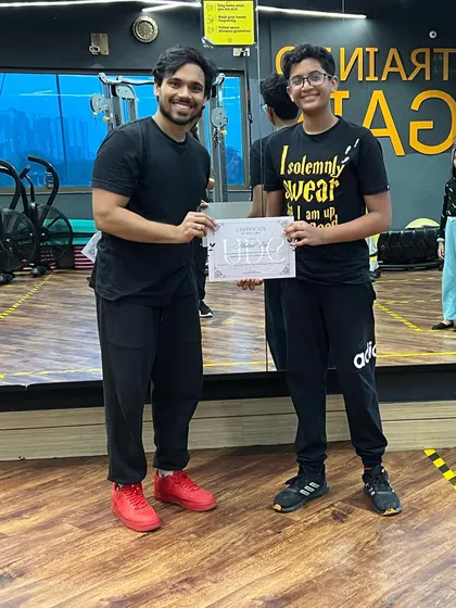 This student proudly holds his certificate after completing his assessment. We support every dancer as they progress through our program.