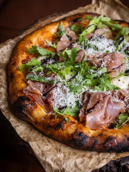 A beautiful Prosciutto and Fig pizza, topped with fresh arugula and a balsamic glaze. This is a perfect example of how I balance classic techniques with gourmet flavors.