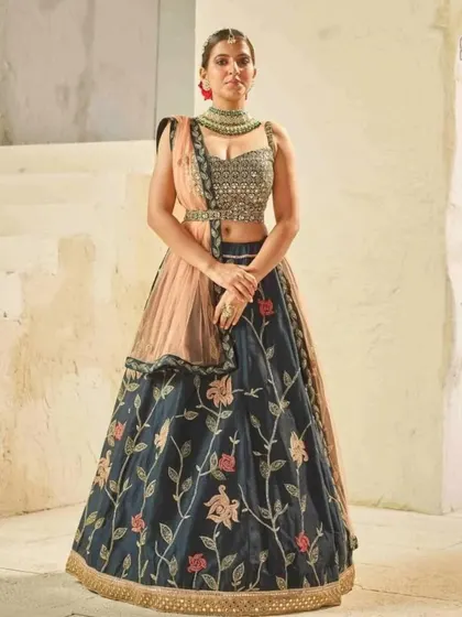 Rent, wear, and shine in our beautiful outfits for every occasion. This dark blue floral lehenga is a timeless piece that you can wear to any wedding event.
