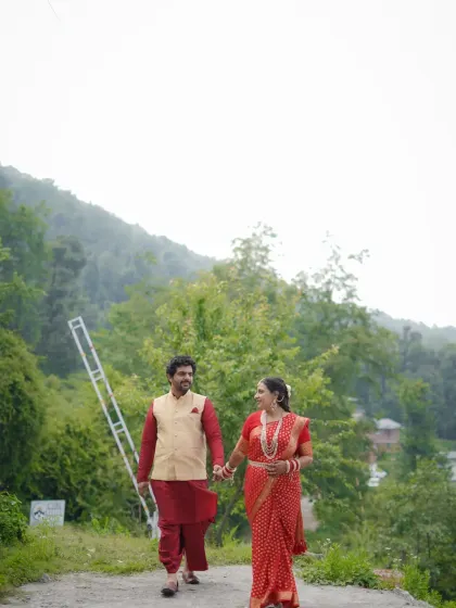 Walking together against a backdrop of misty hills. This image uses negative space to emphasize the couple and the serene, expansive landscape.