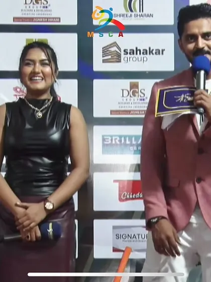 A smiling shot with my co-host. Our chemistry on stage helps keep the audience entertained.
