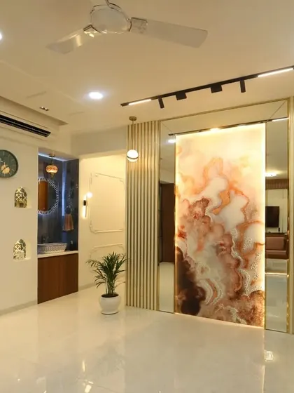 A full view of the common wash basin area, designed to be both functional and beautiful. It features a stunning backlit onyx-style panel that slides to reveal a mirror, decorative niches, and elegant lighting.
