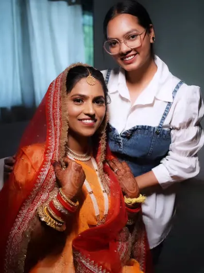 A behind-the-scenes photo of me with the bride, ensuring every detail is perfect before she walks down the aisle.