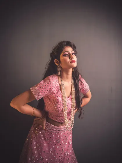 Using a single light source, I created this dramatic, high-contrast fashion shot. The spotlight effect highlights the model and her pink lehenga, making her stand out against the dark background with a theatrical flair.