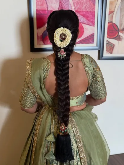 A slightly different angle of the fishtail braid, showing the intricate weaving and the beautiful placement of the hair accessory.