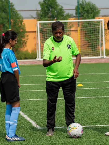 Our experienced coach provides one-on-one guidance to two of our female players, focusing on technique and game intelligence.