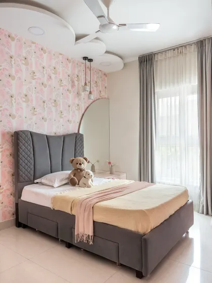 This daughter's bedroom in 'The Flux Abode' is a pink-hued dreamscape. It features a cloud-shaped false ceiling and whimsical koala-print wallpaper for a playful touch.