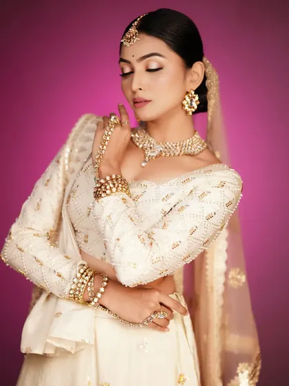 An ethereal look with a white and gold lehenga. You will learn to create soft, romantic makeup for looks like this.
