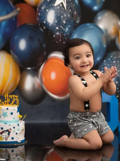 An out-of-this-world space-themed first birthday. The planetary balloons and rocket ship cake create an adventurous backdrop for this little astronaut's celebration.