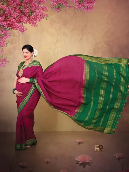 The flowing pallu of the saree creates a sense of movement and grace in this beautiful solo portrait. The floral elements in the background add a soft, romantic touch.