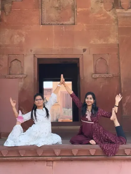 A partner yoga pose, Eka Pada Rajakapotasana (One-Legged King Pigeon Pose), creating a beautiful shape of unity and balance.
