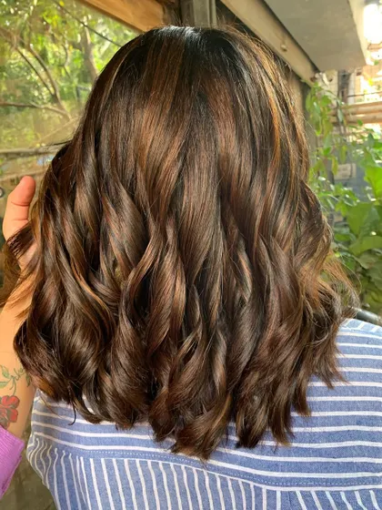 Sprinkled with sun-kissed highlights. A complete makeover from long hair to a chic, layered shoulder-length cut with non-bleach color. (No filter)