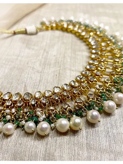 For every occasion, every emotion. This exquisite polki necklace with pearls and emeralds is a truly stunning piece to celebrate with.