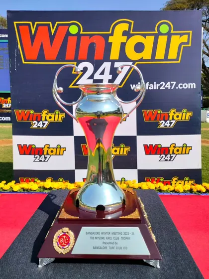 The Mysore Race Club Trophy, a tall and elegant silver cup.
