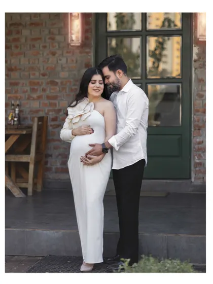 A quiet moment of togetherness for an expecting couple during their outdoor maternity photoshoot.