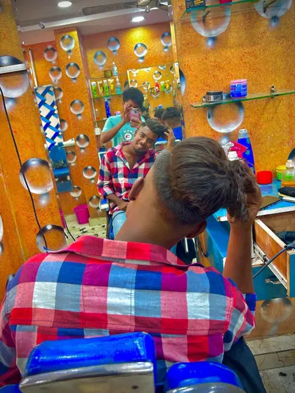 A look from the back as the client checks out his new hairstyle. This angle shows the shape and volume of the cut.