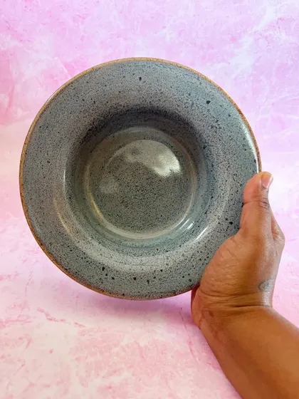 Holding one of the pasta bowls to show its generous size. All my tableware is made with food-safe glazes.