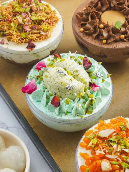 Another angle of the Paan Rosewater Rasmalai globe cake. The vibrant colors and fresh toppings make these desserts visually stunning and highly marketable.
