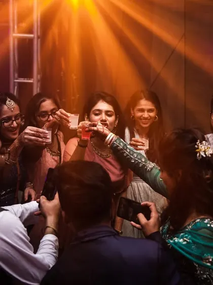 Friends and family raising a toast to the happy couple. A moment of shared celebration.